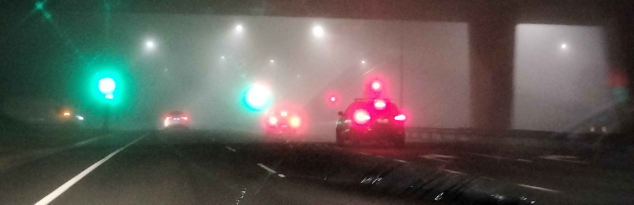 Foggy image of traffic on a highway at night